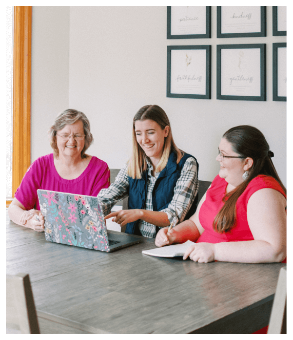 Friends watching a laptop together